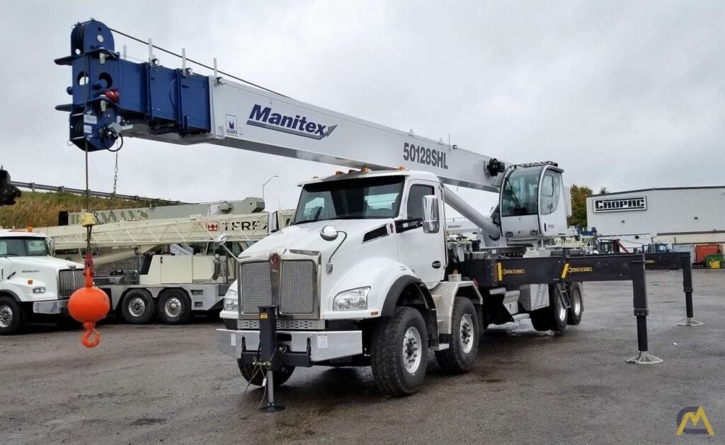 Manitex 50128SHL 50-Ton Crane truck with outriggers extended, ready for a lift. Heavy-duty equipment for construction projects.