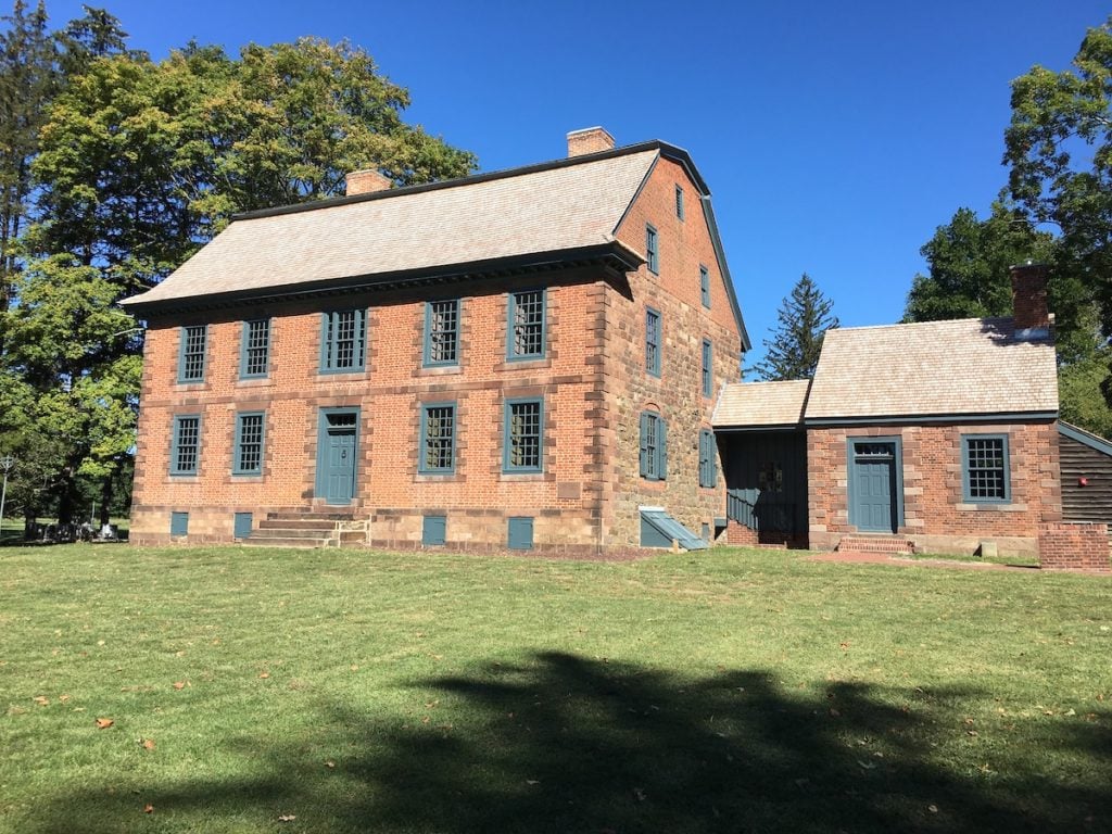 Historic Dey Mansion in Easton, Massachusetts, featuring brick architecture, green windows, and a well-maintained lawn, representing local landmarks related to crane rental services.